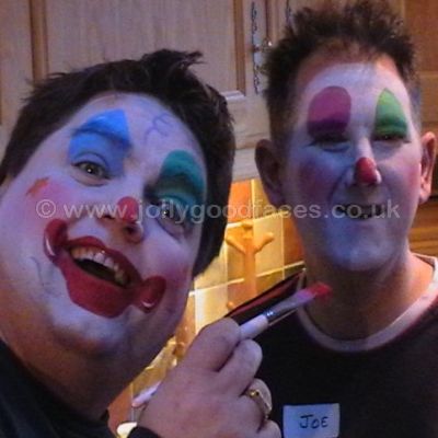 These men are having fun learning to face paint