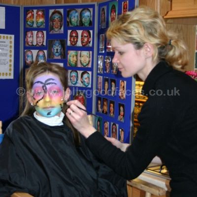 Lady learning to face paint